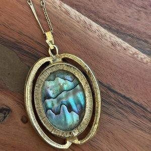 Long gold necklace with iridescent pendant